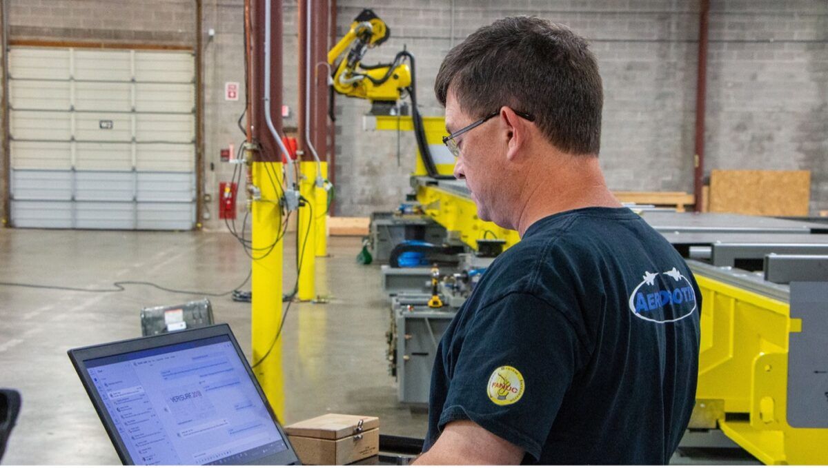 An Aerobotix project manager works to complete a customized robotic solution for a customer. A project manager is an essential part of the 12-step project methodology.