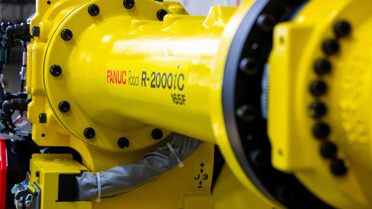 A close up of a R-2000 robot arm by FANUC. It's important to know which kind of robot you need for your application. Credit: Aerobotix