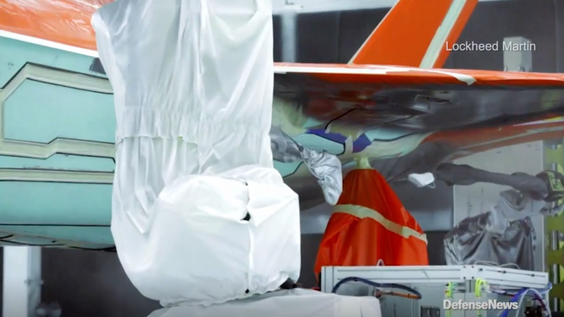 The F-35 II receives low-observable coating under its wing during the manufacturing process. (Credit: Defense News)