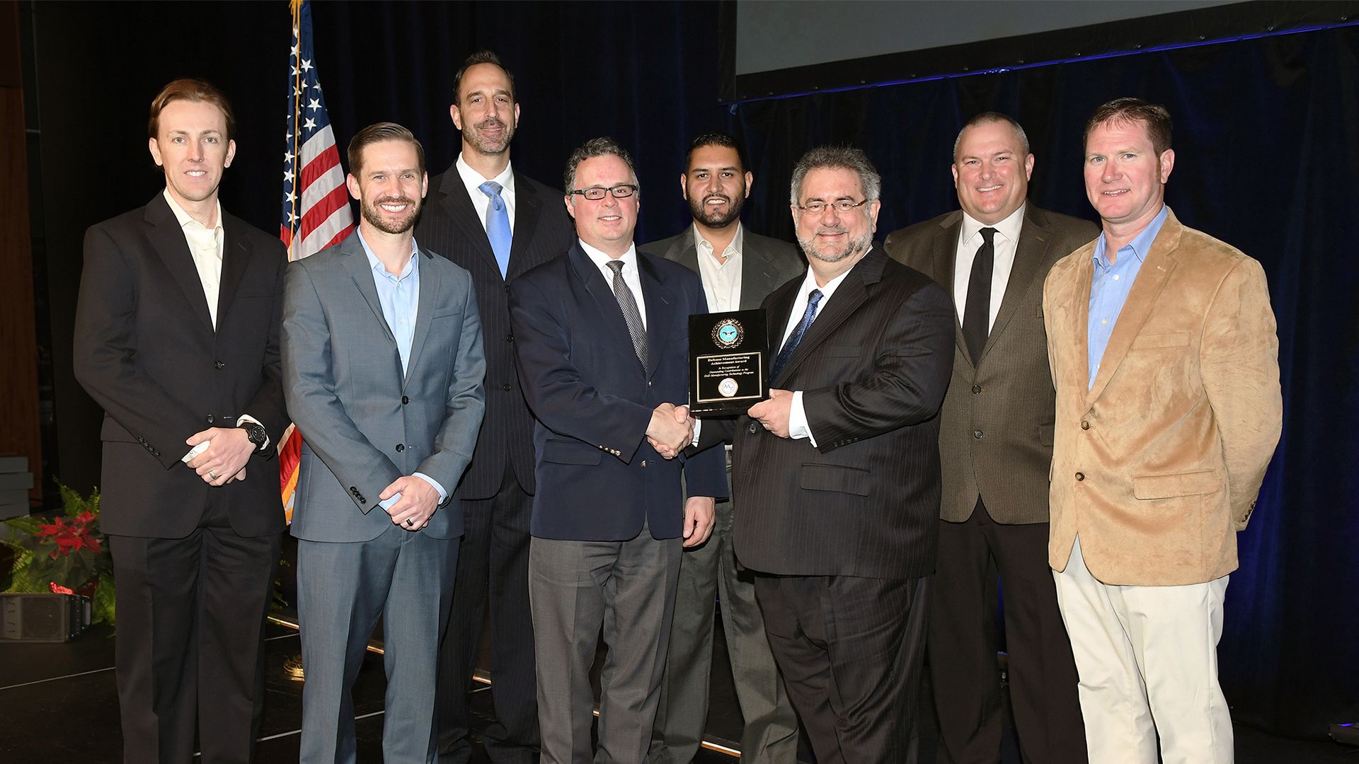 Members of the Automated Aircraft Inlet Coating project are pictured with the 2018 Defense Manufacturing Technology Award. Members include Aerobotix, the Air Force Research Lab (AFRL), Air Force Materiel Command (AFMC), and Lockheed Martin Manufacturing Technology.