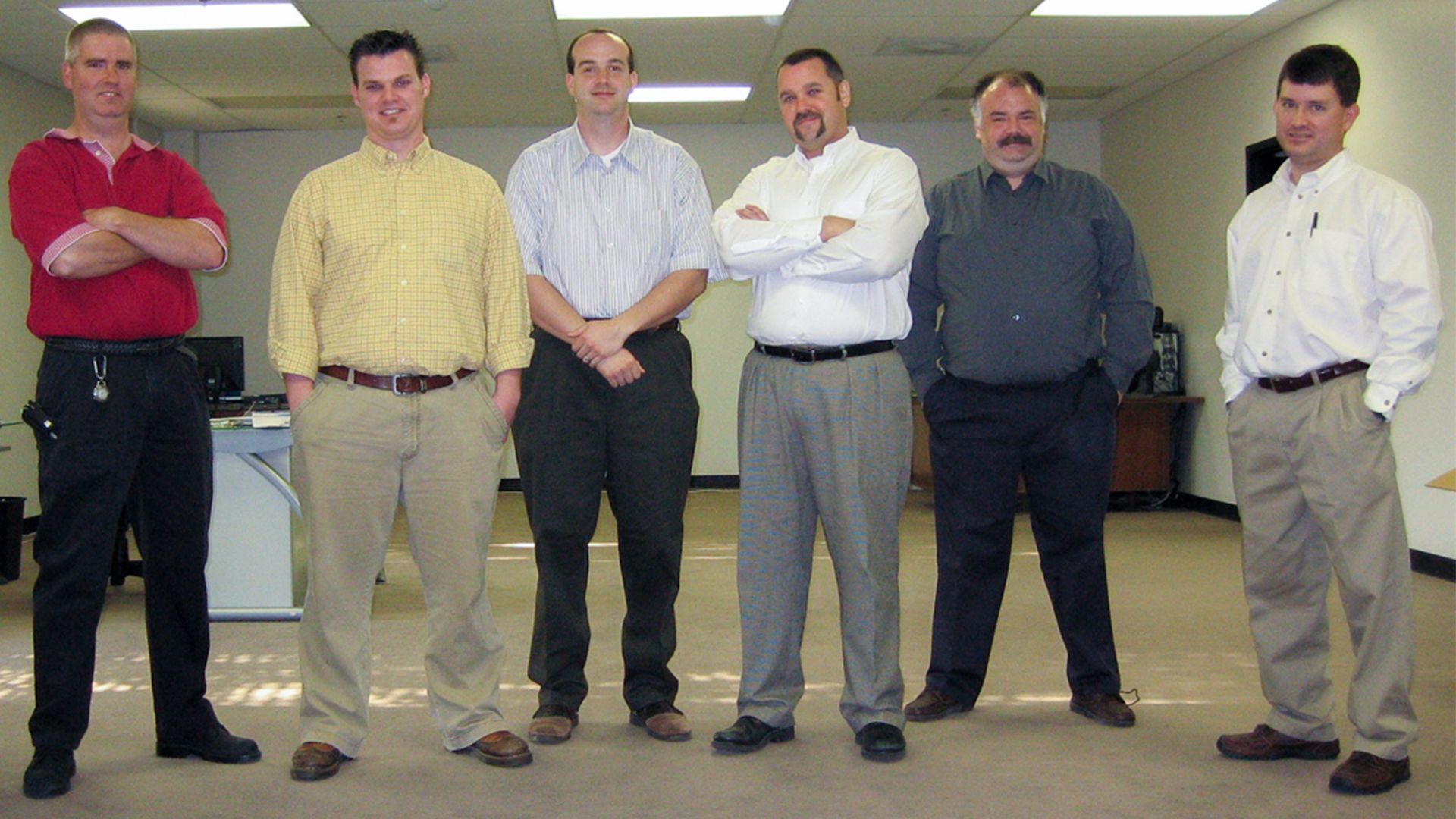 A few of Aerobotix's original founding members pose for a picture in their new office building.
