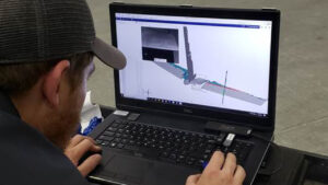 An Aerobotix metrology engineer performing data analysis on the digital model of a Boeing KC-135 Stratotanker.